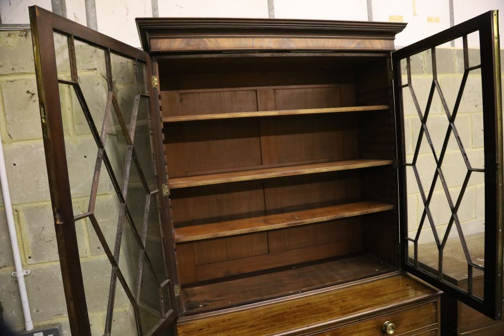 A George III mahogany secretaire bookcase, having astragal-glazed upper section, width 110cm, depth 56cm, height 224cm